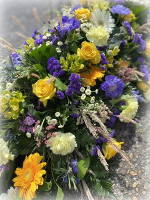 Coffin spray purples, yellows and whites